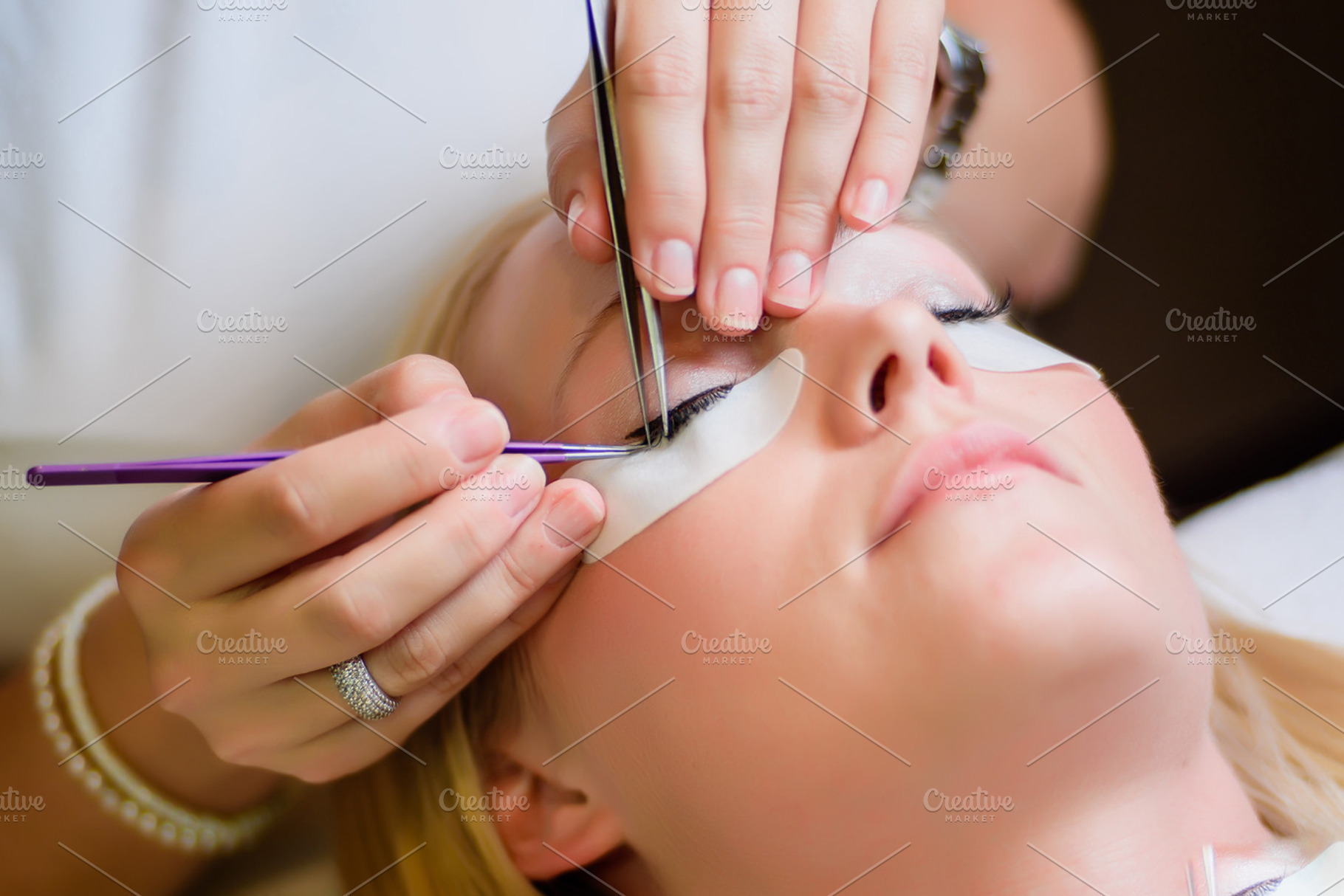 Eyelash extension procedure stock photo containing people and young, a Person Photo by BodiaPhoto
