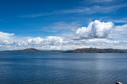 View of Lake Titicaca from Llachon with distant islands and hill, a Photo by GoodGoods