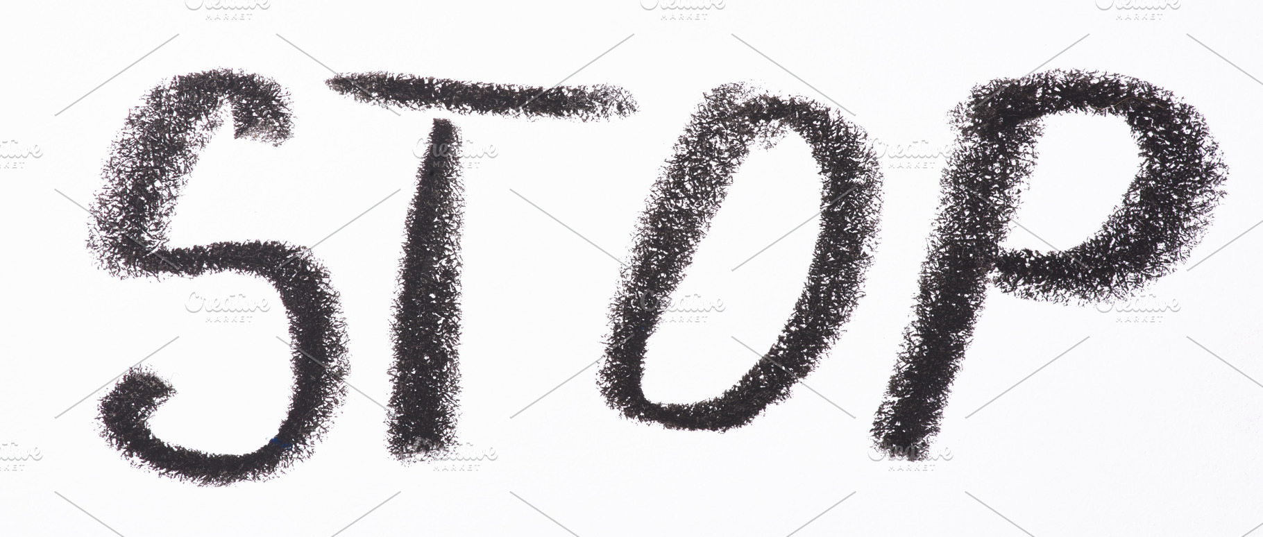 Word STOP is written in bold black pencil on white paper in a ha, an Abstract Photo by ndanko