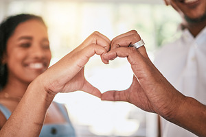 Happy, shape, heart hands and couple with love, happiness and relationship unity together. Smile, solidarity and man and woman with a gesture of loving, caring and harmony as girlfriend and boyfriend, a Photo by Peopleimages.com