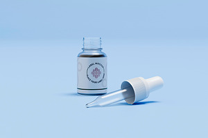 Glass dropper bottle with pipette on blue background, a Health & Medical Photo by RF Images