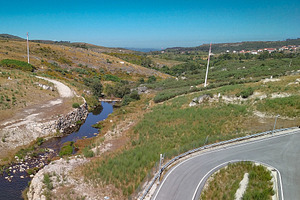 Curved road in dry rural landscape, a Nature Photo by DanFLCreativo