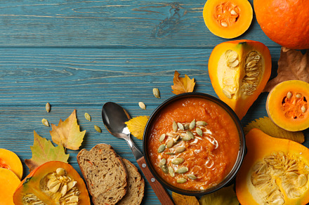 Composition with pumpkin soup with seeds on wooden background, t, a Food & Drink Photo by AtlasStudio PRO