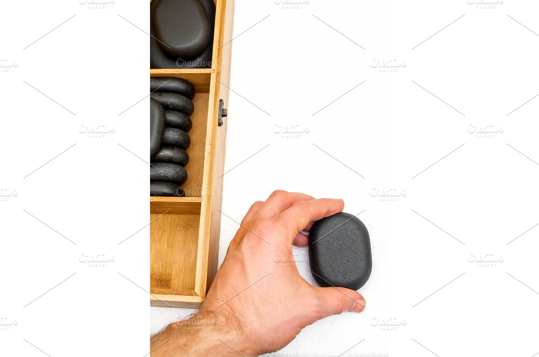 Hot stones for massage in a wooden, a Health & Medical Photo by okskukuruza