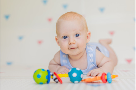Adorable baby playing with colorful