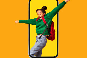 Excited Black Teen Girl Shouting In Cellphone Screen, Orange Background, a Photo by Prostock-Studio