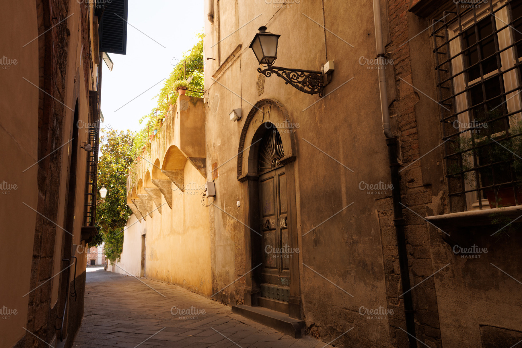 A picturesque narrow alley or street in the historic center of Lucca, an Architecture Photo by Bepslabor