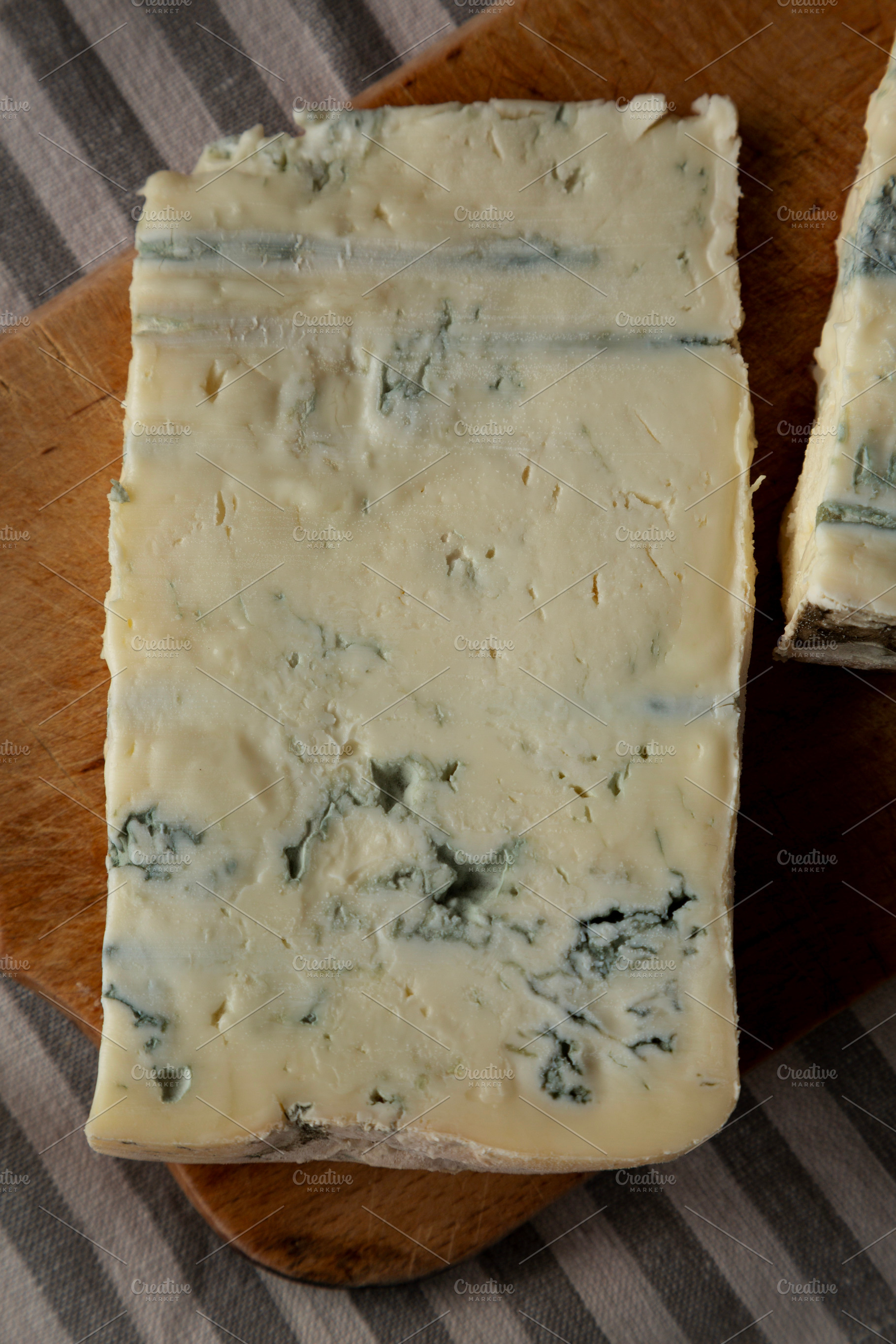 Blue cheese Gorgonzola on a Wooden Board, top view., a Food & Drink Photo by LiudmylaChuhunova