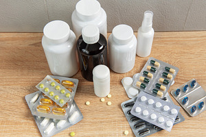 Medicine bottles and blister packs with various pills and capsul, a Health & Medical Photo by Olena Rudo