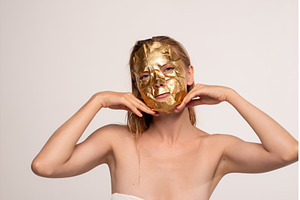 Woman enjoying a luxurious gold, a Beauty & Fashion Photo by volodymyrshtun13795
