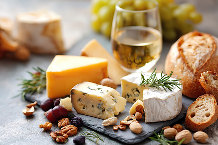 Delicious cheeses with rosemary crusty baguette served with a refreshing glass, a Food & Drink Photo by AlyaAnd