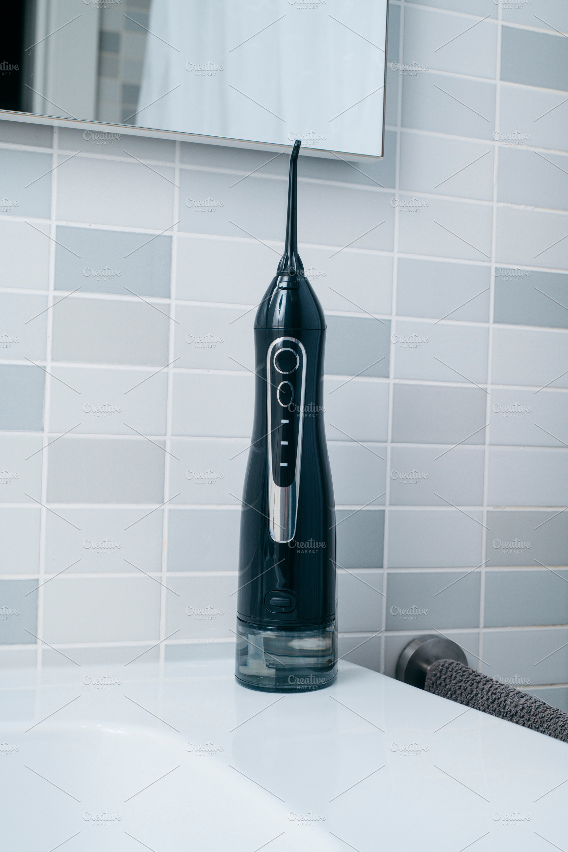 closeup of an oral irrigator in a bathroom, a Photo by Nito