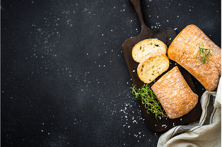 Ciabatta bread on wooden board on, a Food & Drink Photo by Nadia-nb