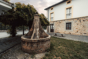 Stone fountain in Cabrales square, an Architecture Photo by SkyNext