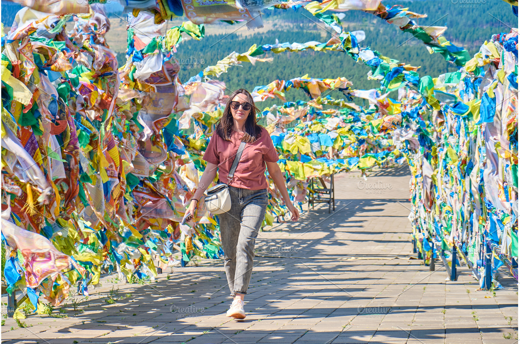 A girl walks under an arch with, an Architecture Photo by PhotoXab