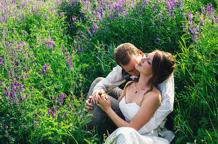 Portrait of the bride and groom resting on a lavender background containing, a Person Photo by ruslan117