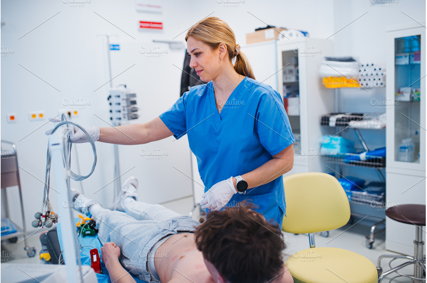 Nurse removing EKG electrodes after, a Technology Photo by HalfPoint