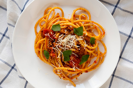 Homemade Bucatini all Amatriciana Pasta in a white plate, top vi, a Food & Drink Photo by LiudmylaChuhunova
