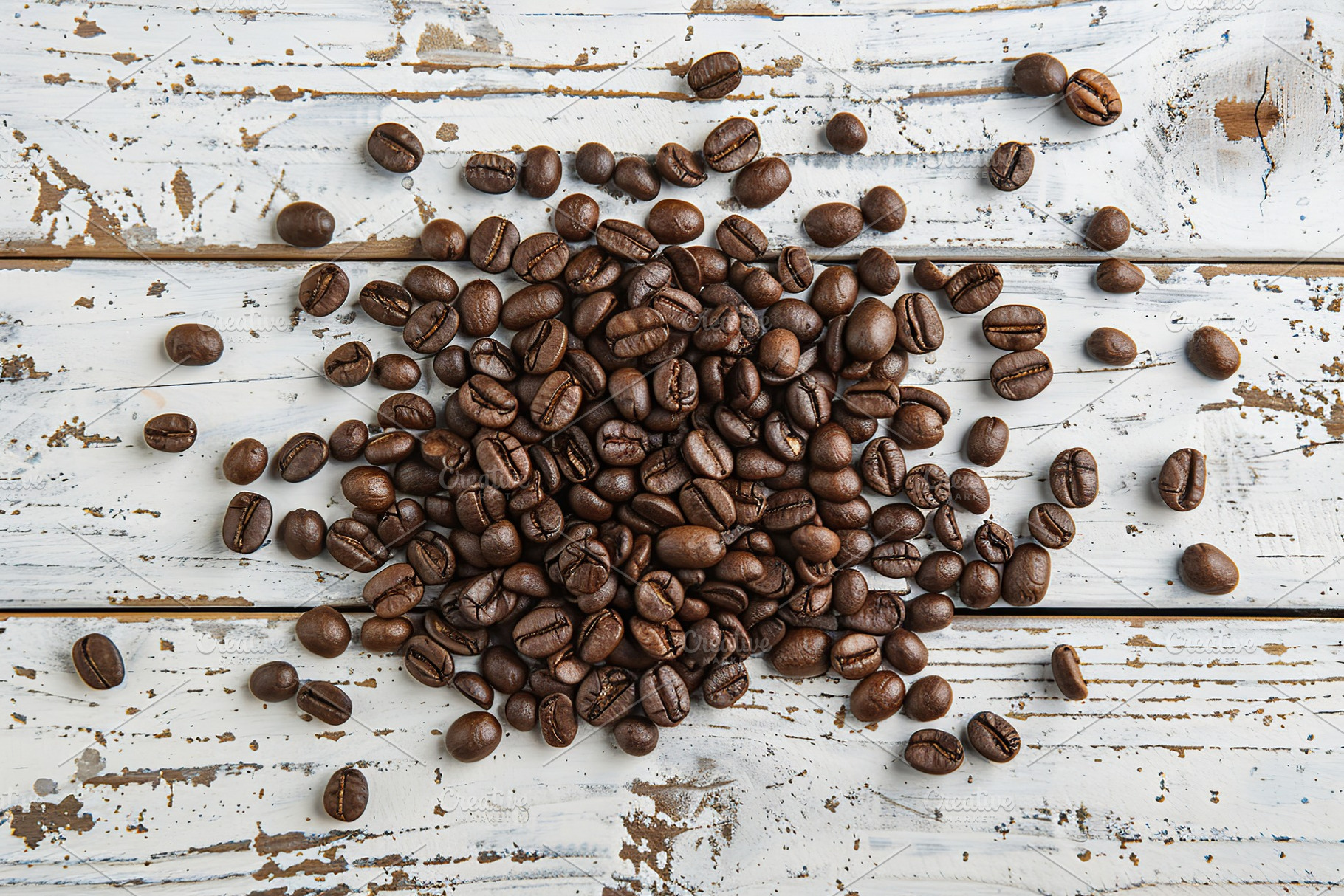 Heap of coffee beans on wooden table, a Food & Drink Photo by AlyaAnd