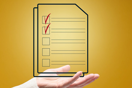 Female hand and document with check boxes on a yellow background, a Business Photo by ndanko