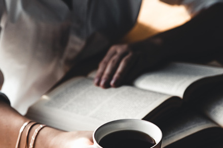 Woman reads book and drinks coffee stock photo containing background and woman