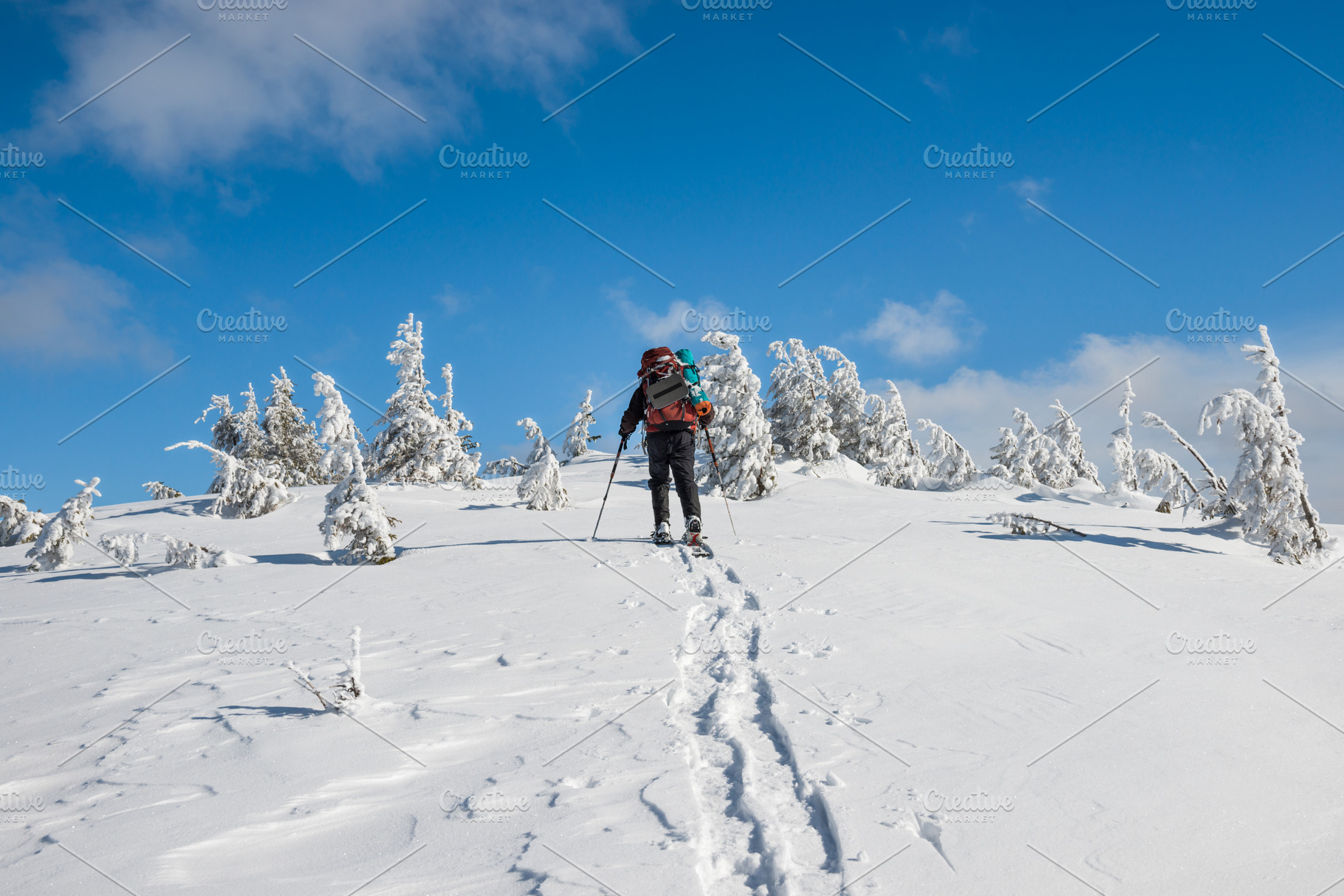 Man hiking on snow in mountains, a Person Photo by Vapi