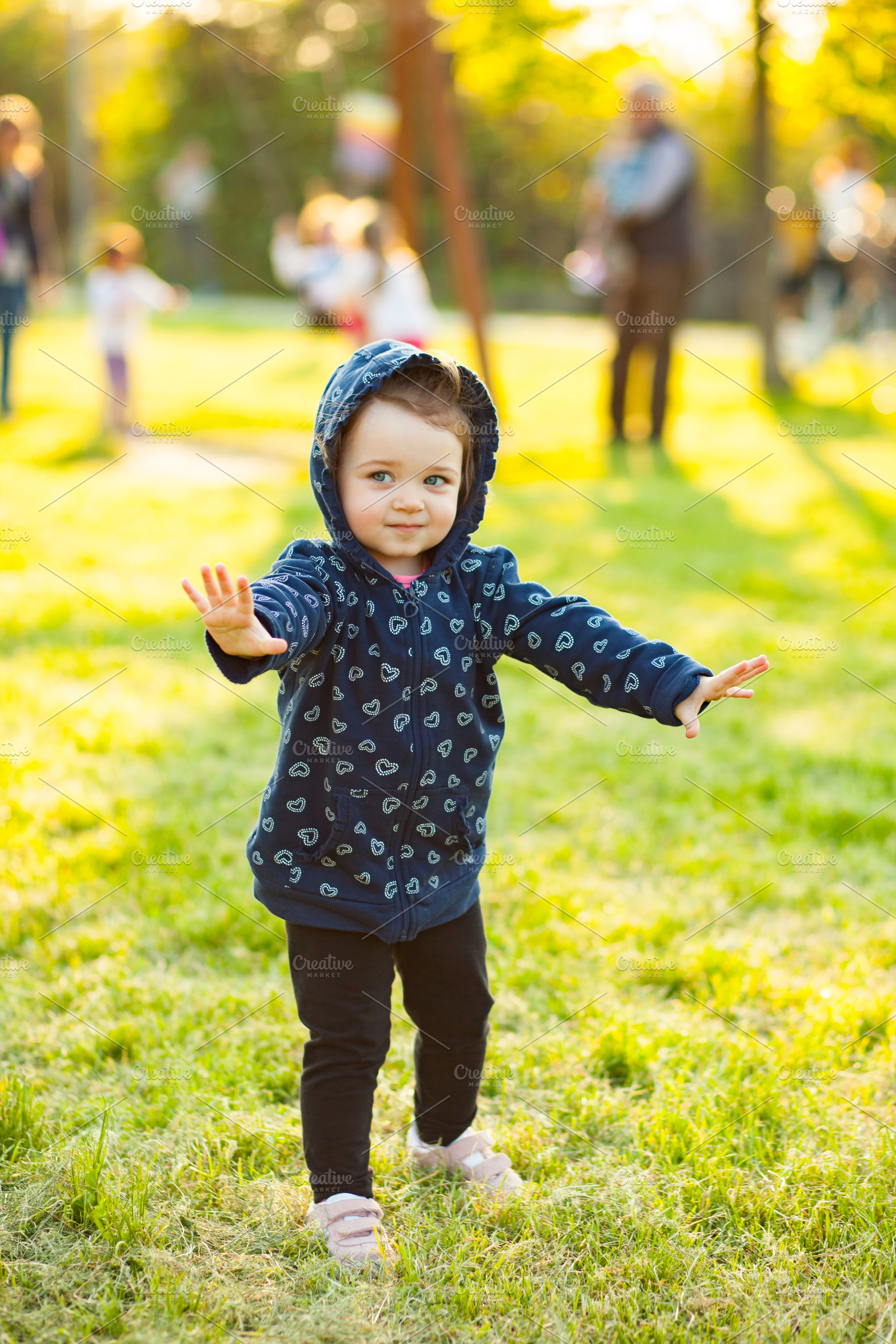 Little baby girl plays in the park stock photo containing people and portrait, a Person Photo by Antonio Gravante Market
