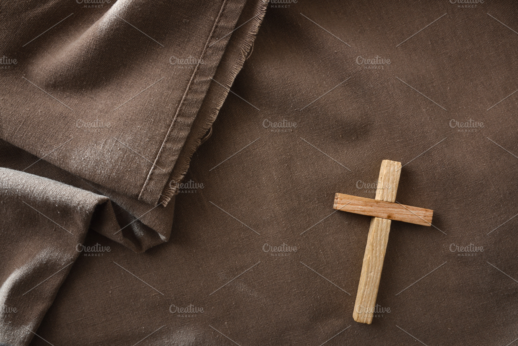 Wooden Cross on Brown Fabric Background, a Holiday Photo by Davizro's Market