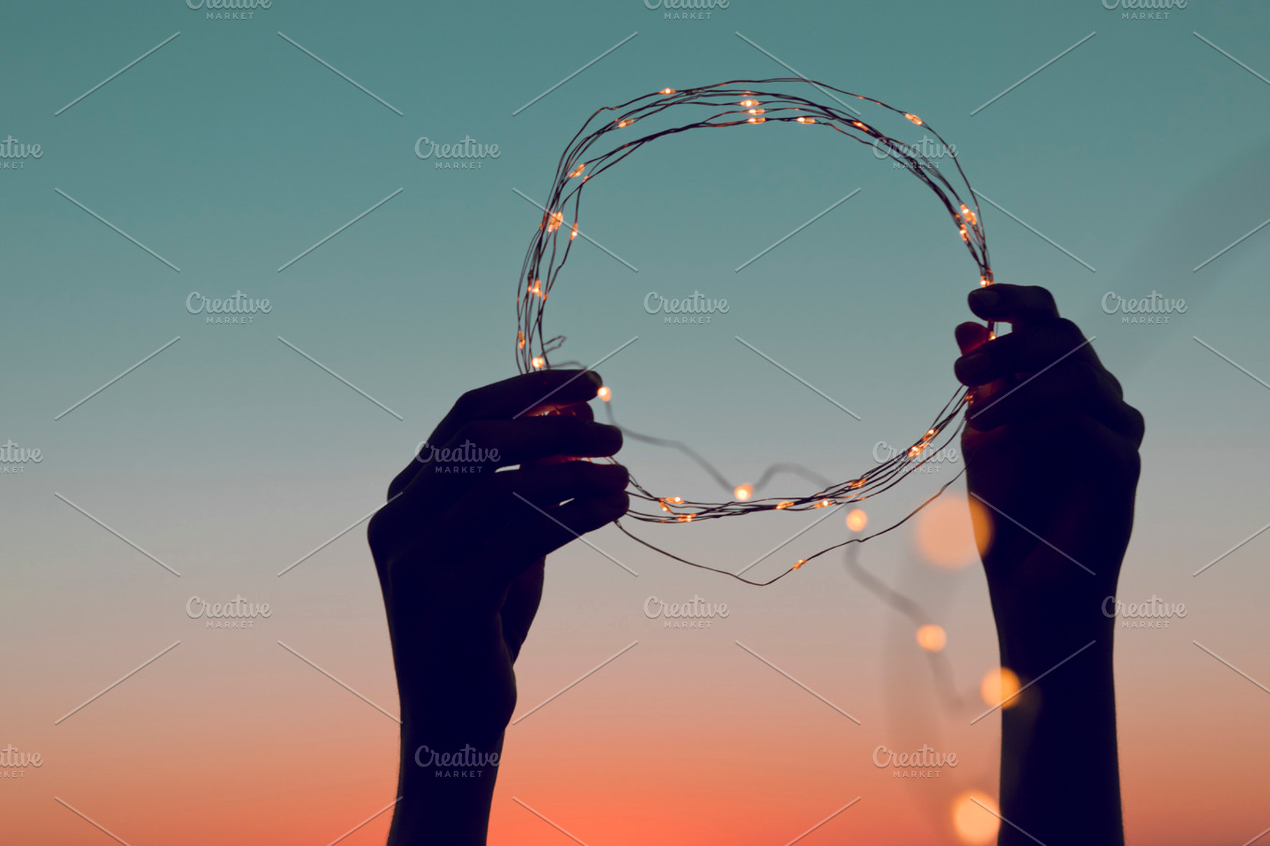 Hands holding a circle of lights, a Person Photo by Fossilized Tree Sap