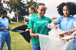 Students, recycle and community volunteer project with young people cleaning plastic and trash. Happy, recycling and charity work for a sustainability, eco friendly and ecology service outdoor, a Photo by Peopleimages.com