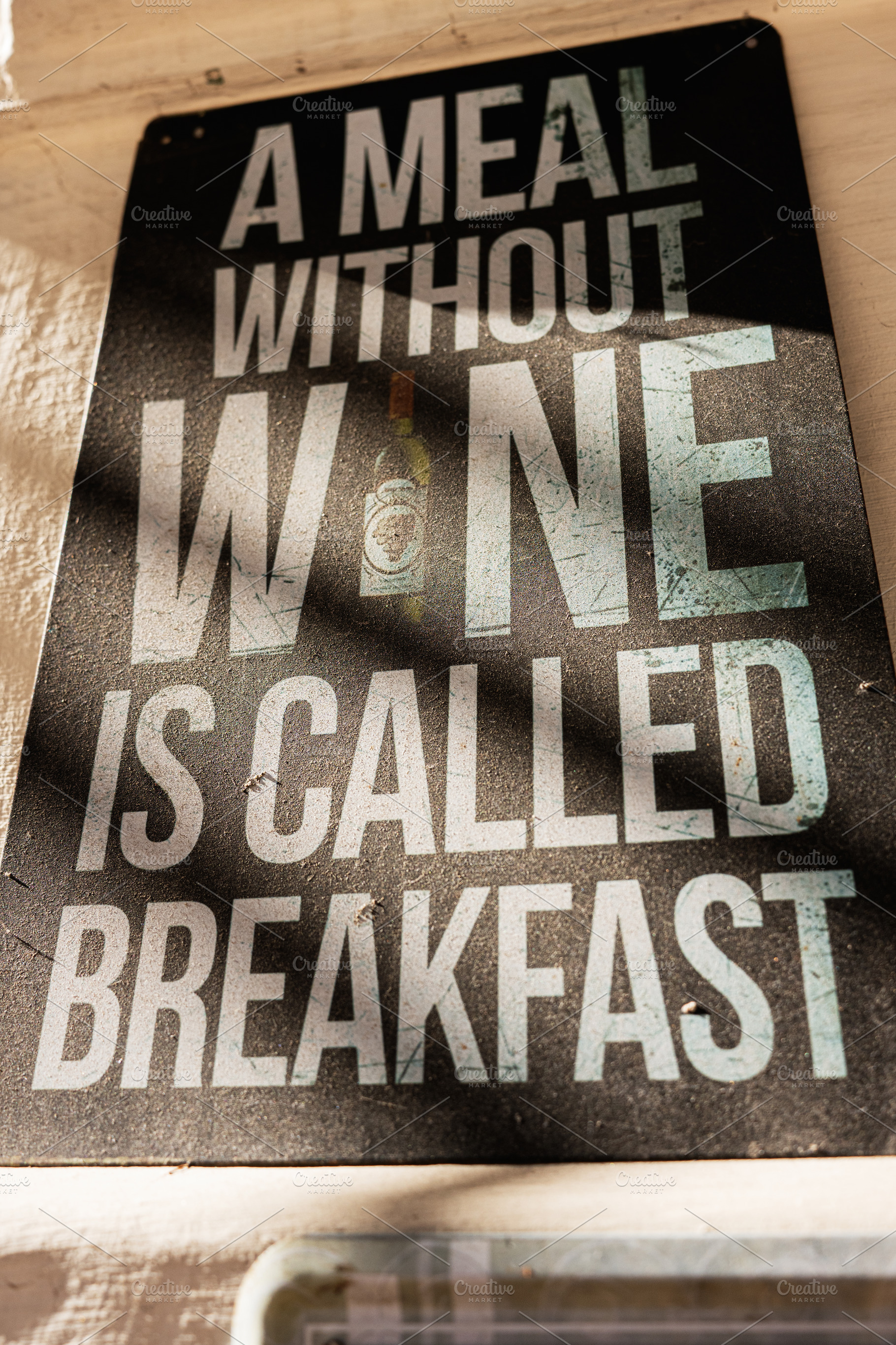 Humorous sign about wine and meals in a rustic setting, a Photo by AS photostudio