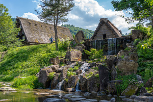 Traditional houses and waterfall pond in Shirakawa-go, Japan, an Architecture Photo by GoodGoods