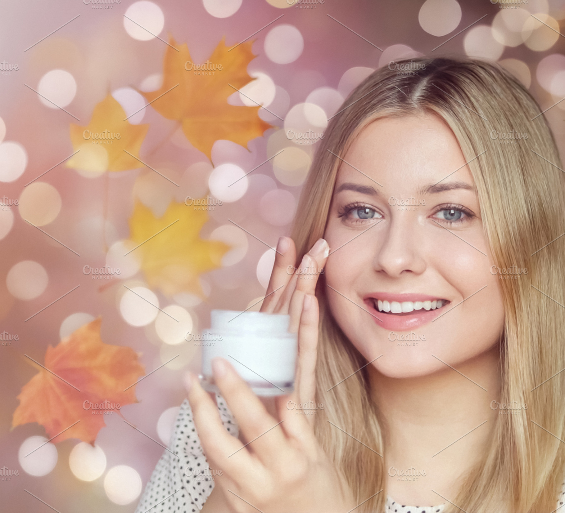 Young woman applying face cream, moisturizing skin for autumn be, a Person Photo by Studio ANNA