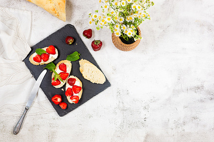 Sandwich with strawberries, soft cheese, mint and honey, a Food & Drink Photo by vimart