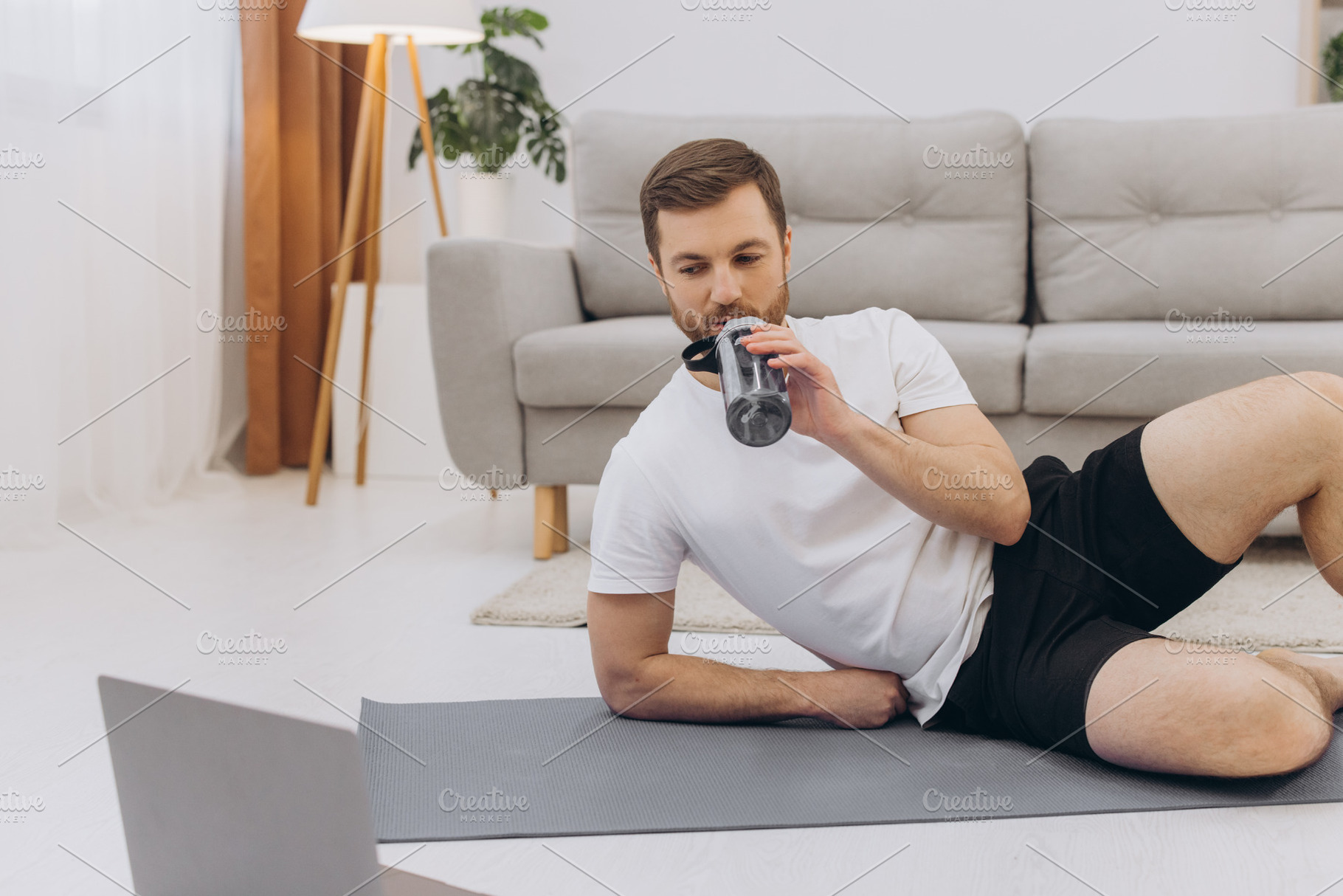 Handsome adult man using laptop and drinking water while having, a Sports & Recreation Photo by Cherkas Photography