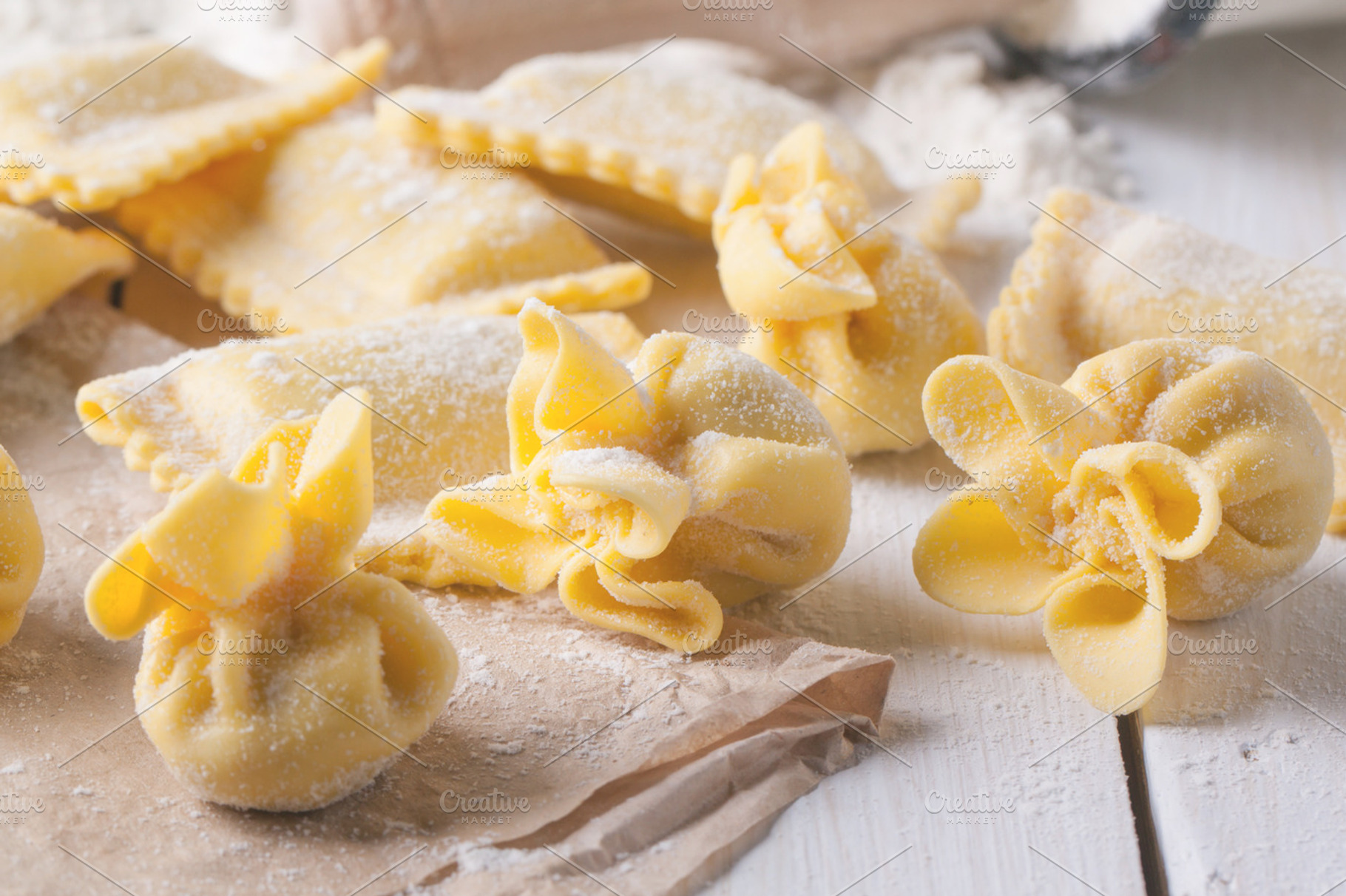 Pasta ravioli on flour with basil containing pasta, ravioli, and italian