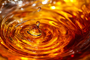 Amber Liquid Splash Macro, a Background Photo by Ales Munt