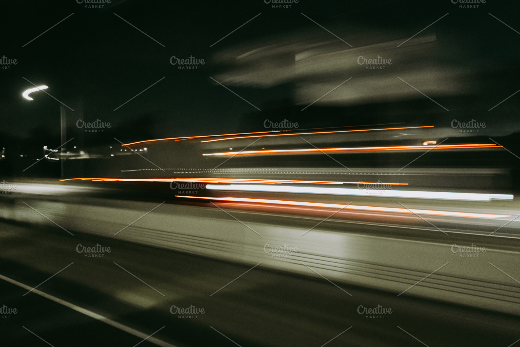 Light trails of a moving vehicle at night on the road, a Background Photo by GoodGoods