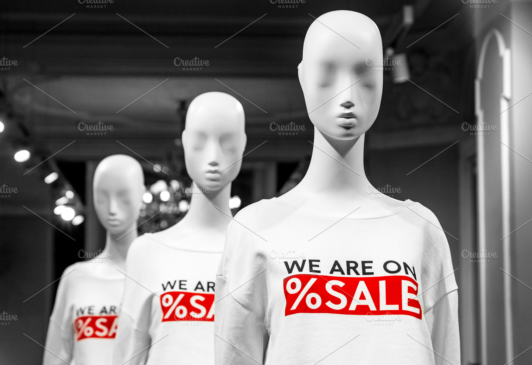 Mannequins with sale signs in a shop, a Business Photo by BOOCYS