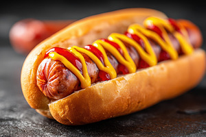 Grilled sausage hot dog with mustard and ketchup, a Food & Drink Photo by AlyaAnd