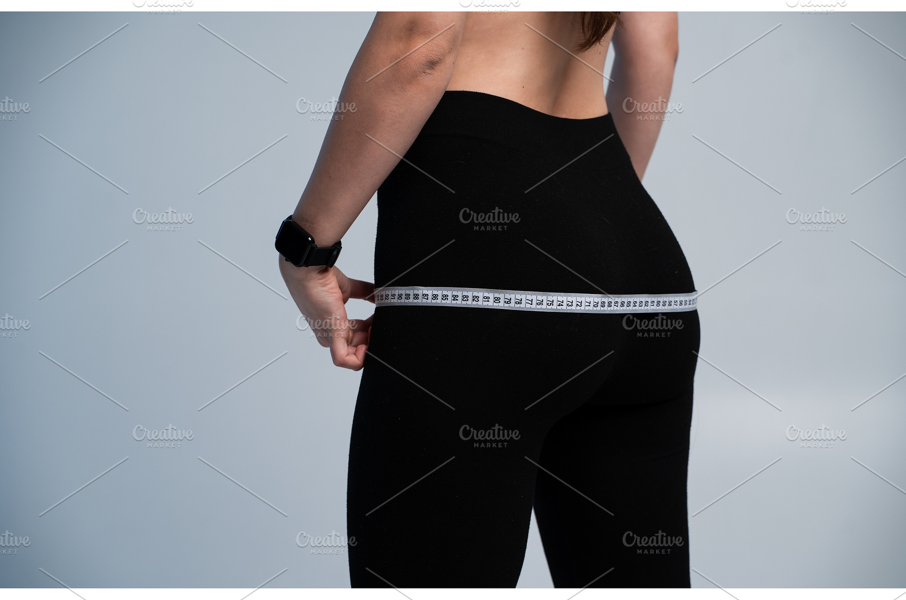 Woman measuring hips, focusing on, a Sports & Recreation Photo by volodymyrshtun13795