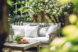 Garden sofa and wooden coffee table on a peaceful patio, enjoyin, a Photo by Studio ANNA