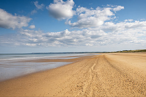 Omaha Beach, Normandy, World War II landing site with vast sandy, a Photo by Studio ANNA