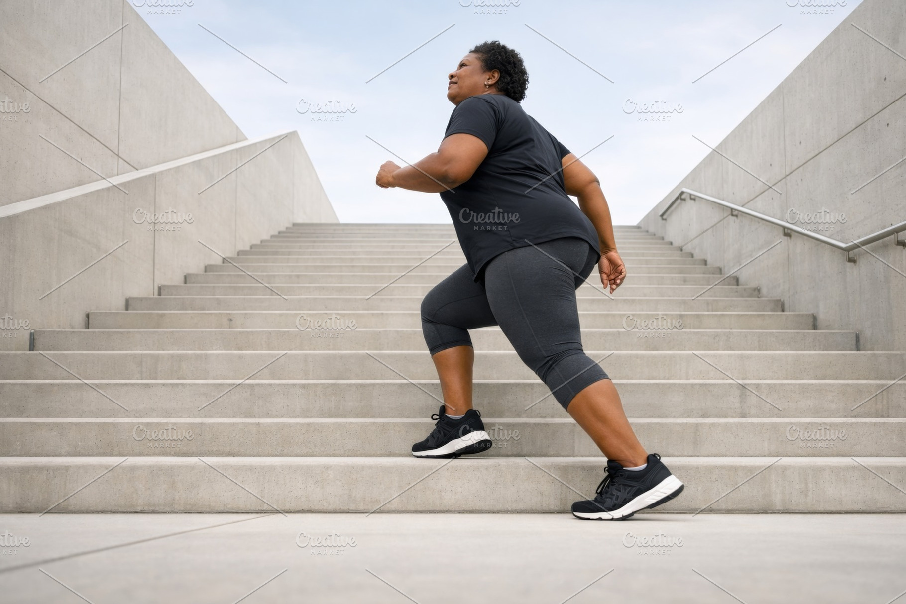 African American woman exercising on, a Photo by Dvoevnore photos