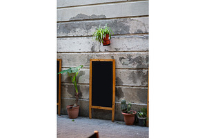 Blank wooden sandwich board standing, a Background Photo by volodymyrshtun13795