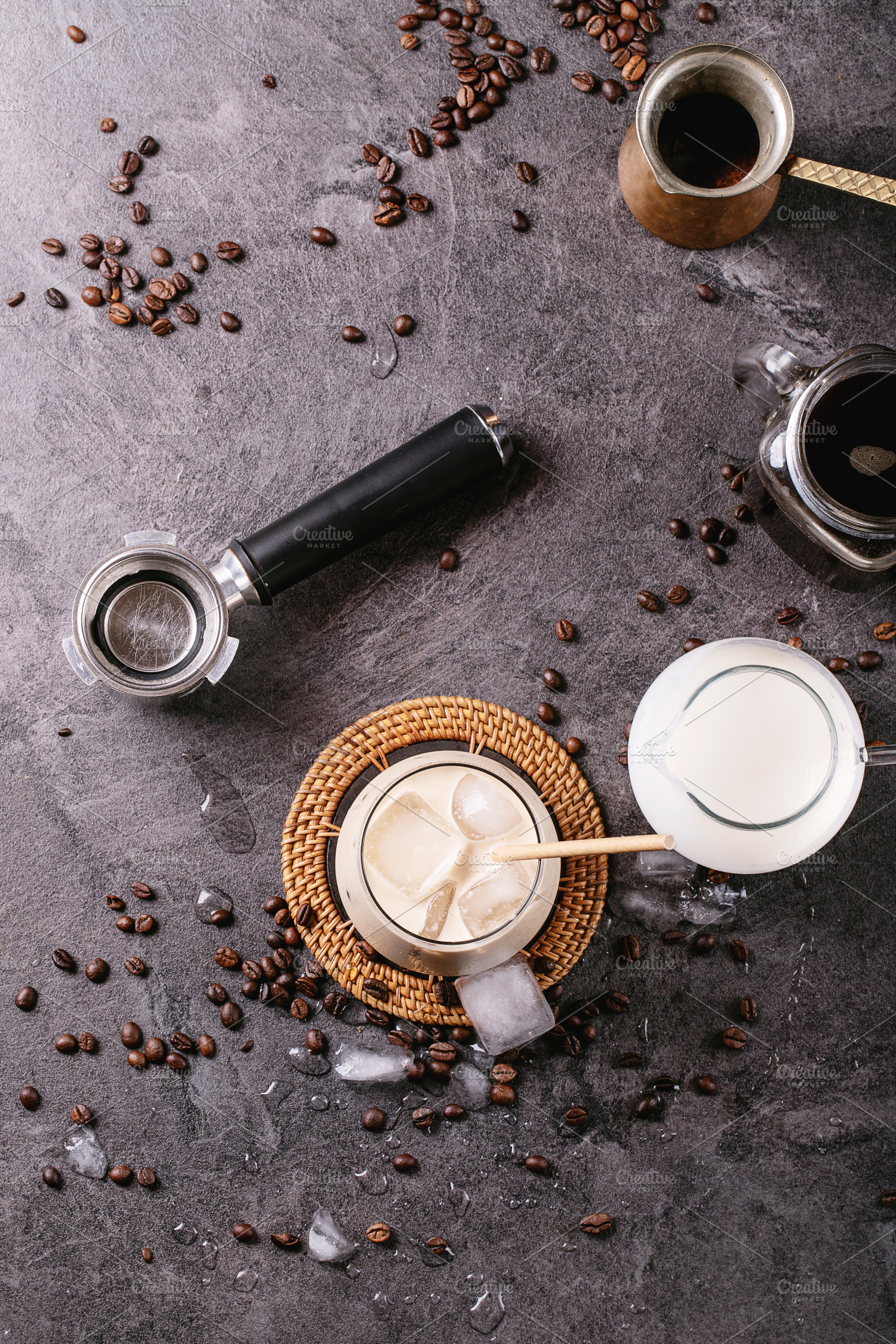 Glass of ice coffee with ice cubes served with cream, a Food & Drink Photo by RomanDebree