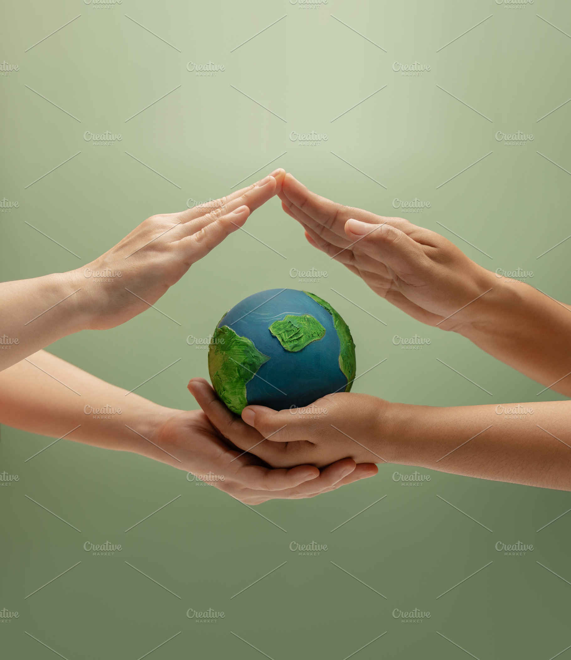 Two people forming a protective roof over Globe. Environmental a, a Photo by salmon.black