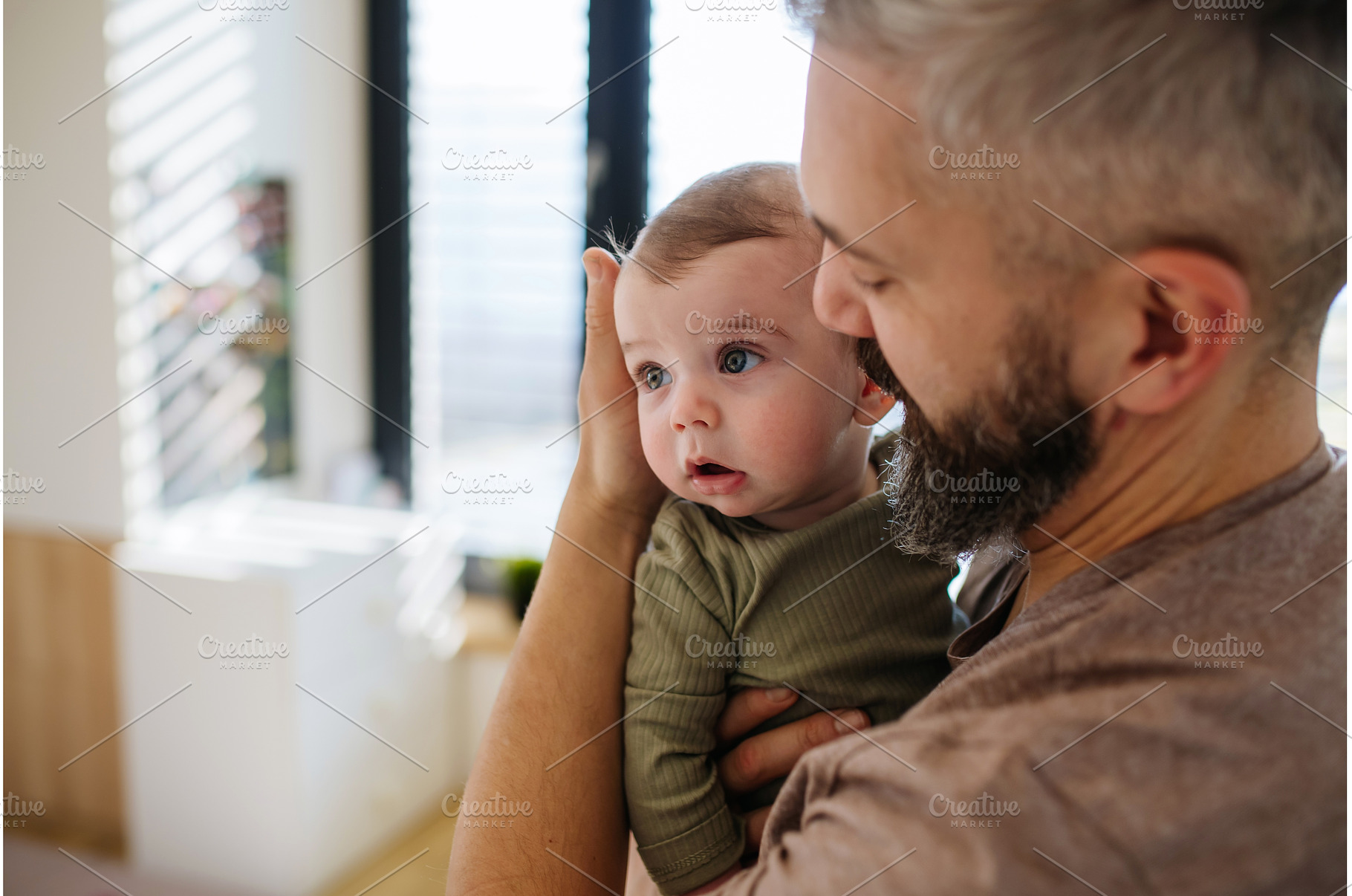 Portrait of father holding baby son, a Person Photo by HalfPoint