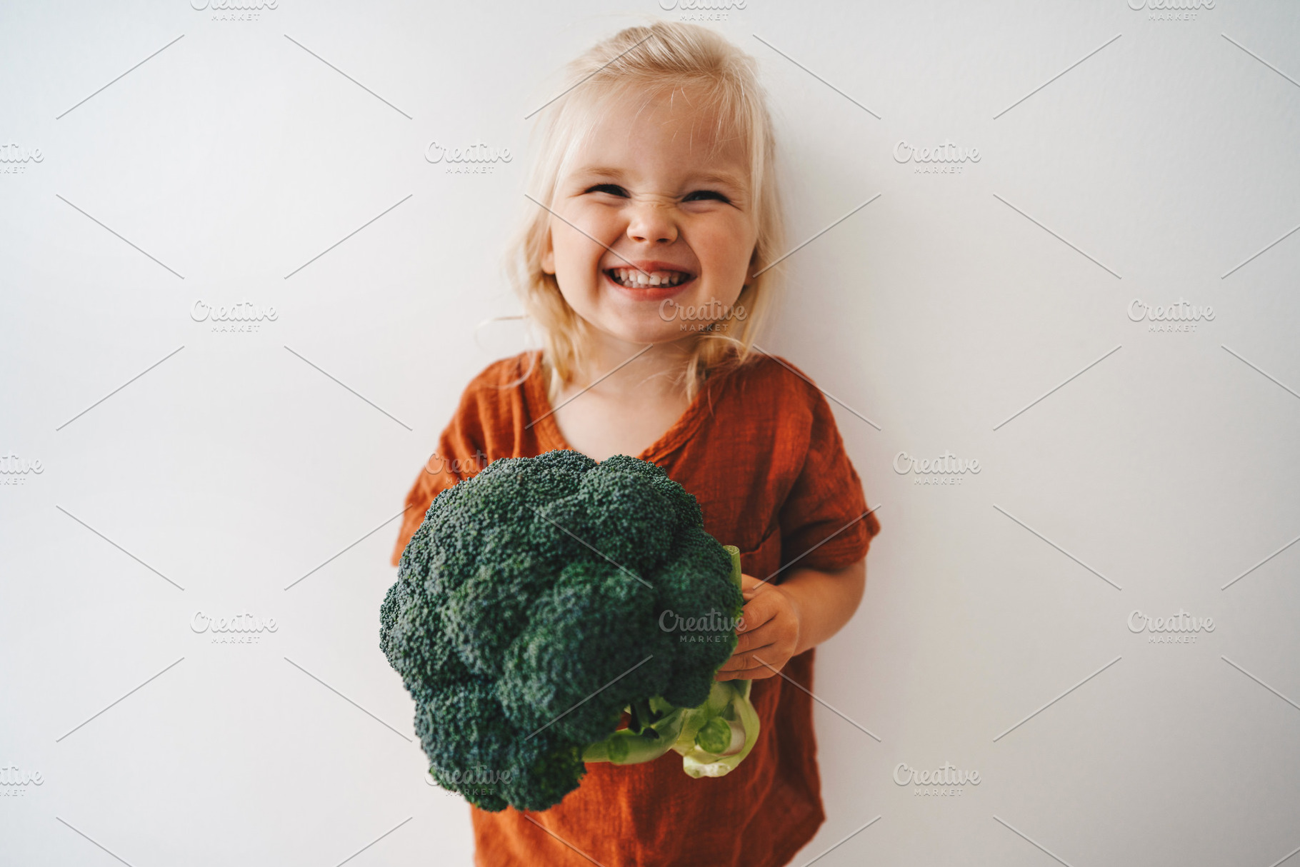 Child with broccoli vegetable healthy food vegan cooking eating sustainable lif, a Person Photo by e v e r s t