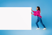 Full length of young African American lady pushing blank white paper banner wit, a Photo by Prostock-Studio (Thumbnail 2 of 2)